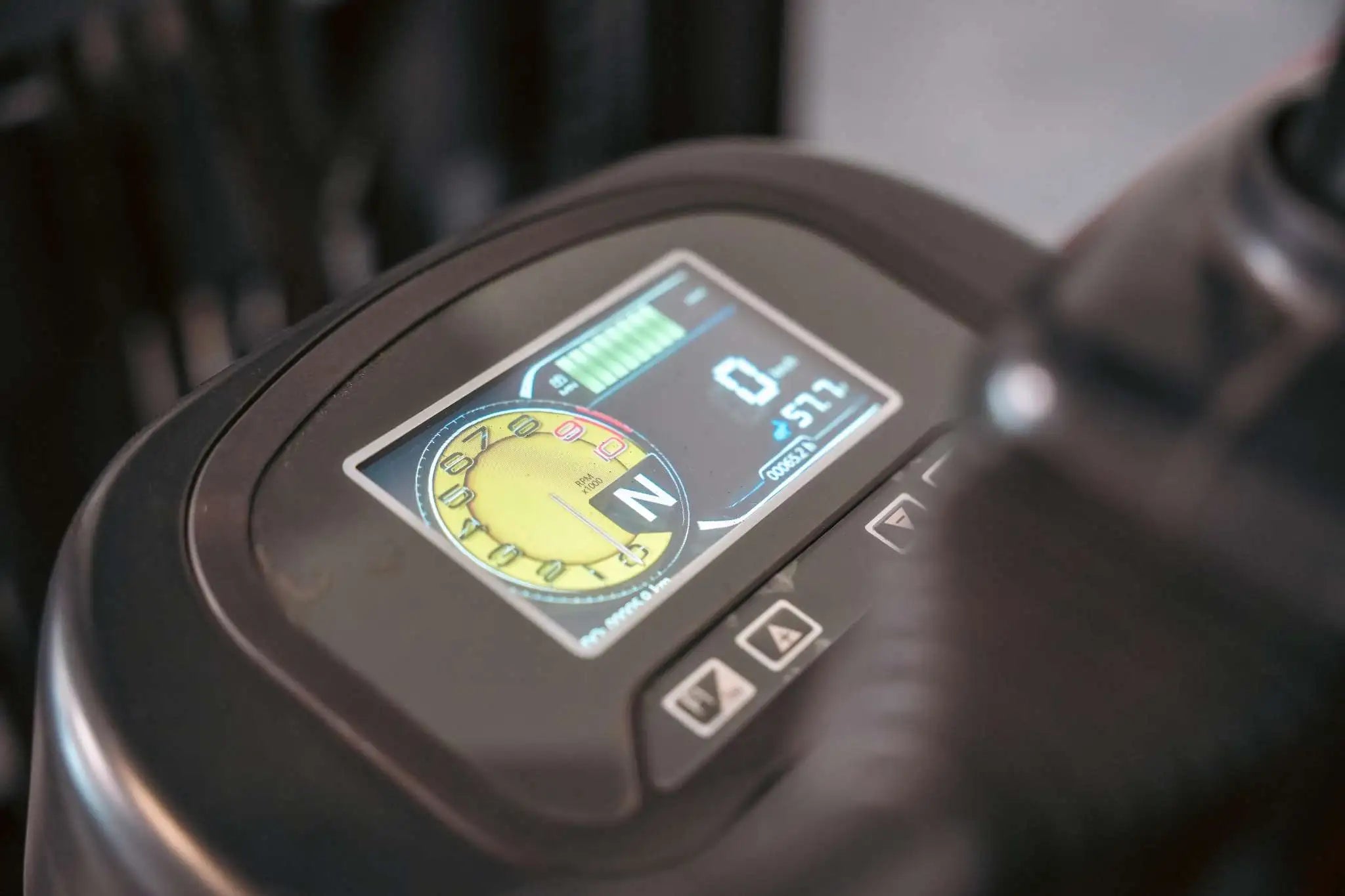 LUXX LX-4400 Compact forklift colour digital dashboard displaying RPM gauge, neutral gear indicator, battery charge bars, and hour meter on the instrument panel.