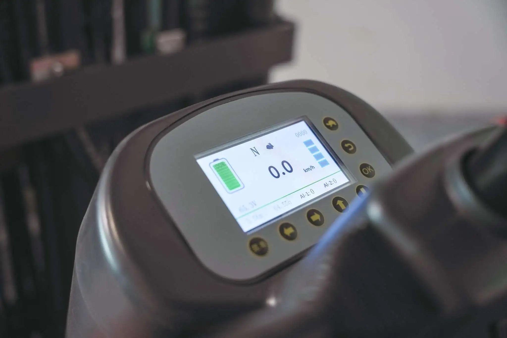 LUXX LX-7700 forklift digital dashboard display showing battery level, speed readout at 0.0 km/h, and control buttons on the instrument panel.